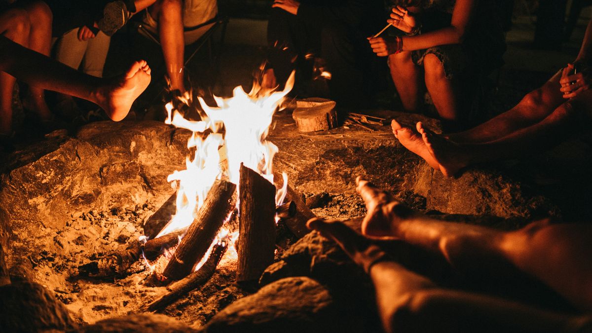 Men sitting around a campfire at night