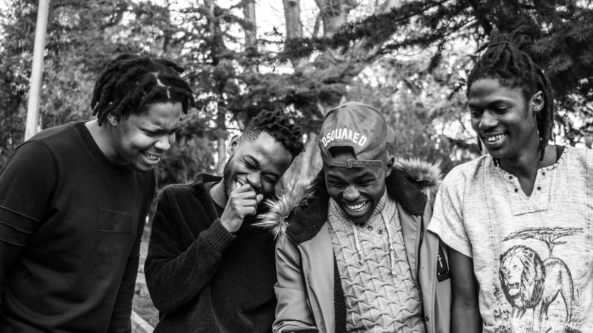 Four young men sharing a laugh